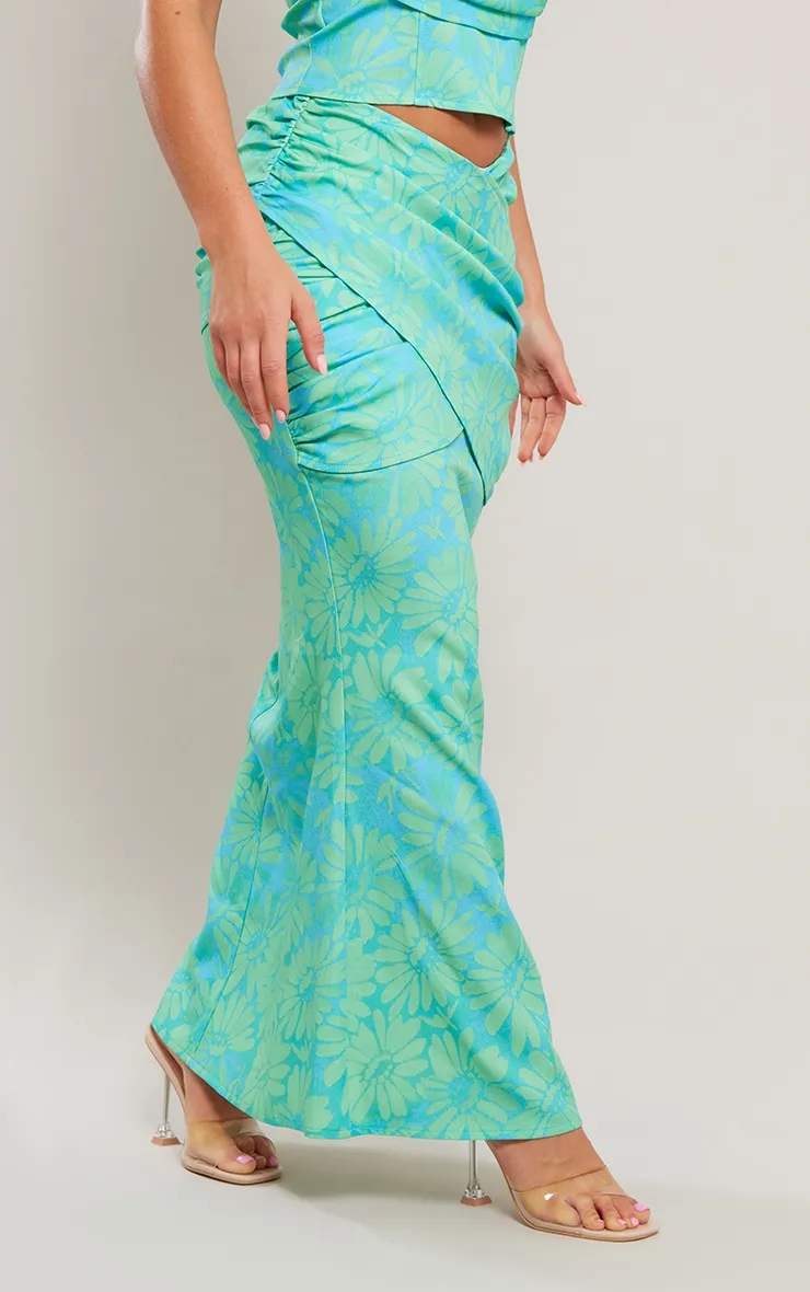 Jupe mi-longue tissée turquoise fleurie à devant drapé